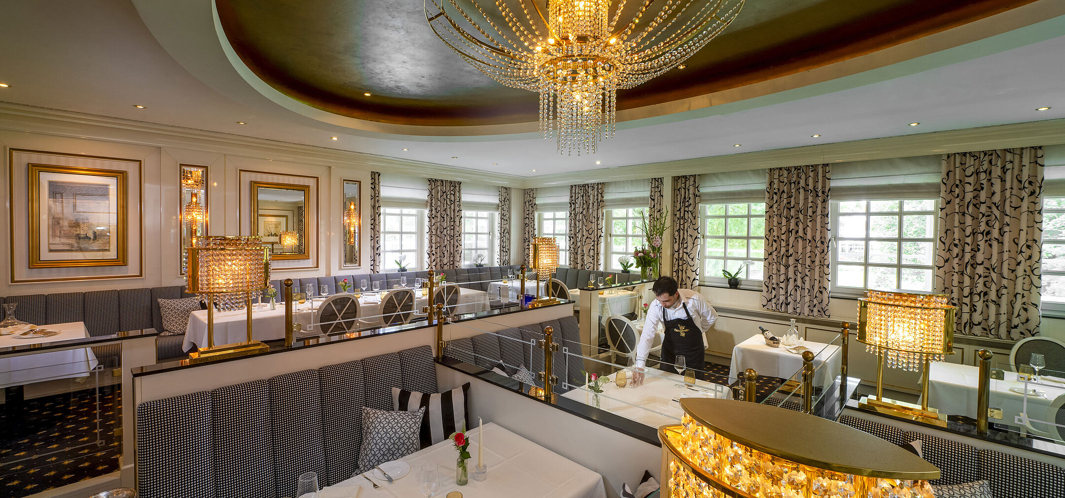 Elegant Orangerie restaurant at Maritim Seehotel Timmendorfer Strand with luxurious decor and set tables.