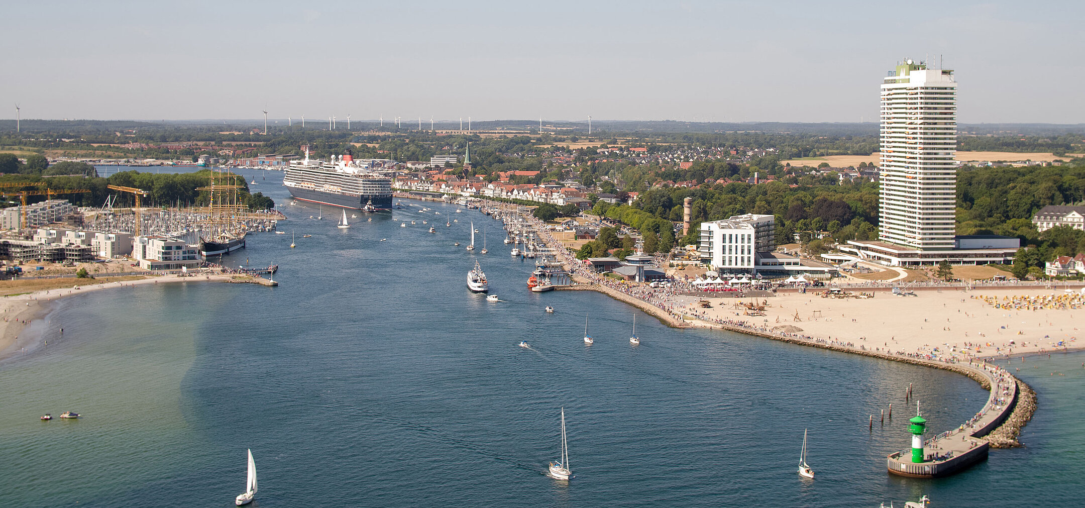 Aerial view of Travemünde with cruise ship, promenade and Maritim Hotel by the Baltic Sea
